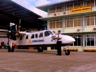 Roraima’s 18-seater Trislander Aircraft with Captain Gerry Gouveia (Jr) standing next to it.