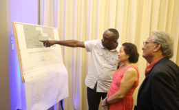  In this Keno George photo, the designer of Step by Step’s dream building, Kenrick Thomas (left) outlines his plan to First Lady Sandra Granger and Minister of Education Dr Rupert Roopnaraine.