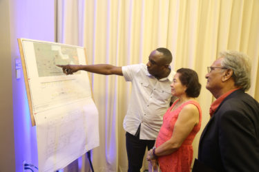  In this Keno George photo, the designer of Step by Step’s dream building, Kenrick Thomas (left) outlines his plan to First Lady Sandra Granger and Minister of Education Dr Rupert Roopnaraine.