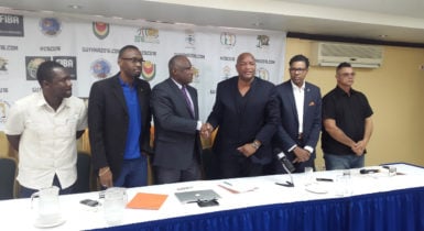 CBC President Glyne Clarke (3rd from left) and GABF President Nigel Hinds shaking hands following the signing of the agreement signaling Guyana as the host for the CBC u16 Male and Female Championships while CBC Vice President Patrick Haynes (2nd from right), NSC chief Christopher Jones (2nd from left) and YBG Director Chris Bowman (left) look on 