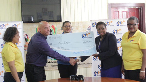 In photo at extreme left and right respectively are GTT PROs Nadia De Abreu and Allison Parker while GTT Marketing Director Daniel Jilesen (second from left) presents the cheque to Dawn Holder, Chairperson, GuyExpo Committee. At centre is GuyExpo Coordinator Tameka Sukhdeo-Singh. 