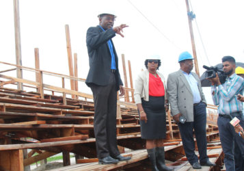 Public Infrastructure Minister David Patterson (left) explaining some of the works to be done on the stands with Minister Annette Ferguson (middle) and Larry London (right), who formerly spearheaded the works at the troubled site 