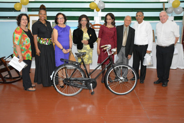 Third to sixth from left: First Lady,  Sandra Granger, Kella Ramsaroop,  Pamela Ramsaroop and Yesu Persaud. Bishop Francis Alleyne is pictured first from right. The Ramsaroops have owned the Humber bicycle displayed since 1940.  (Ministry of the Presidency photo)