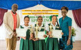 Presidential Advisor on the Environment, Rear Admiral (ret'd) Gary Best and Head of the Office of Climate Change,  Janelle Christian flank the first, second and third place winners of the Green Bartica Spelling Bee contest (Ministry of the Presidency photo)