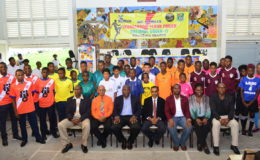 Members of NAMILCO including Financial Consultant Fitzroy McLeod (third from left) and the GFF executive committee including President Wayne Forde (third from right) pose with members of the participating clubs following the launch of the Thunderbolt Flour Power National Under-17 Intra-Association Football League last week. (Orlando Charles photo)