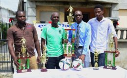 Members of the C & A Unique Incorporated/South Quakers Ministry inaugural Golden Jubilee Futsal Knockout Championship launch party from left to right Tourney Coordinator Carlos Griffith, Lawrence December, Alistair Griffith and Ryan Patterson posing with the respective tourney trophies.
