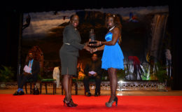 Wednesday night capped off a banner season for Alisha Fortune after she was crowned the 2015 Sportswoman-of-the-Year. Above she receives her award from Minister Nicolette Henry. (Orlando Charles photo)

