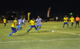 Curtis Kellman (left) of GFC trying to fight off the challenge of Pele’s Jamal Cozier (2nd from left) at the Leonora Sports Facility in the GFF Stag Beer Elite League