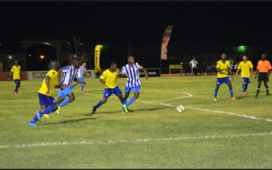 Curtis Kellman (left) of GFC trying to fight off the challenge of Pele’s Jamal Cozier (2nd from left) at the Leonora Sports Facility in the GFF Stag Beer Elite League 