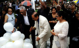 President David Granger and Prime Minister Moses Nagamootoo along with their spouses writing their personal commitments to the promotion of social cohesion on white helium filled balloons, which were later released. (OPM Photo)
