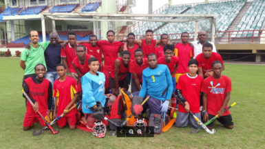 From Left to Right-Standing: Robert Fernandes (Head Coach), Dwayne Alleyne (Assistant Coach), Ato Greene, Jael Gaskin, Andrew Stewart, Nyron Joseph, Omar Hopkinson, Shaquille Leung, Daniel Hooper, Leon Bacchus, Keon McKenzie, Paramanand Dindial, Mark Sargeant (Captain) and Barrington Browne (Physical Trainer) Kneeling: Hilton Chester, Meshach Sargeant, Michael Hing, Medroy Scotland, Rosario Ramsammy and Ian Burke (Standby Player). Absent from photo is Aroydy Branford.