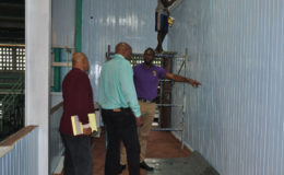 Director of Sport, Christopher Jones (right) makes a point during yesterday’s inspection of works at the Cliff Anderson Sports Hall in the presence of GABF President, Nigel Hinds (centre) and Facility Manager, Bashur Khan.