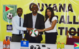 GFF Vice-President Rawlston Adams (centre) posing with DDL Brand Manager Larry Wills (left) and Ansa McAl PRO Darshannie Yussuf following the conclusion of the press conference declaring the two entities commitment to the international friendly against Canada’s Olympic Team.