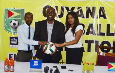 GFF Vice-President Rawlston Adams (centre) posing with DDL Brand Manager Larry Wills (left) and Ansa McAl PRO Darshannie Yussuf following the conclusion of the press conference declaring the two entities commitment to the international friendly against Canada’s Olympic Team.