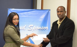 GFF Vice-President Bruce Lovell (right) collecting the sponsorship cheque from GBTI Public Relations and Marketing Manager Pamela Binda.
