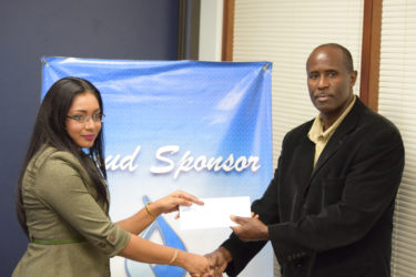 GFF Vice-President Bruce Lovell (right) collecting the sponsorship cheque from GBTI Public Relations and Marketing Manager Pamela Binda. 