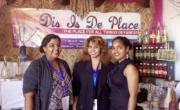 From left: Samantha Ramah, Crystal Baptiste and Aneisa Douglas in front of their booth at GuyExpo yesterday.
