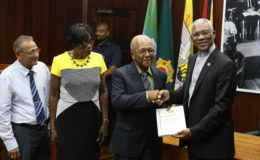 Chairman of the Commission of Inquiry (CoI) into the Public Service Harold Lutchman (second from right) presents the CoI’s report to President David Granger as commissioners Sandra Jones (second from left) and Samuel Goolsarran look on.  (Photo by Keno George)