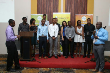 CEO of Intellect Storm Rowen Willabus (right) and Intellect Storm partner Ronson Grey (left) present the team (centre) that worked tirelessly in the design and development of Directory.gy.    