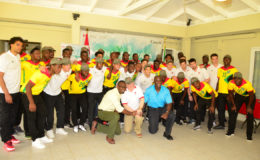 Canadian High Commissioner to Guyana Pierre Giroux, GFF Vice President Bruce Lovell and NSC Chief Christopher Jones shaking hands in solidarity while the members of the Golden Jaguars and Canada Olympic Team embrace.