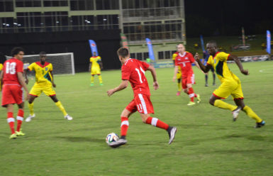 Ben Fisk (no.11) of Canada on the attack down the left flank while being pursued by Tichard Joseph at the National Stadium in Providence during their international fixture. (Orlando Charles photo) 