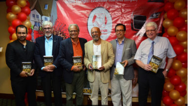 Minister of Education Dr. Rupert Roopnarine and author of the History of Guyana Cricket Professor Clem Seecharan (both center) share a photo with other distinguished guest during Friday’s book launching. (Orlando Charles photo)