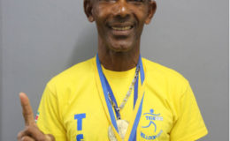 Marathon stalwart Llewellyn Gardner posing with his spoils following his exploits at the Telesur 10 kilometre events in Suriname earlier this month.
