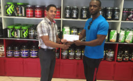 CEO of Fitness Express, Jamie McDonald hands over the sponsorship cheque to Paul Adams.
