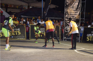 Joel McKennon (2nd from left) of Magics battling for possession of the ball against a  Retrieve Unknowns player during their team’s matchup in the Linden Guinness of the Streets at the Mackenzie Market Tarmac.