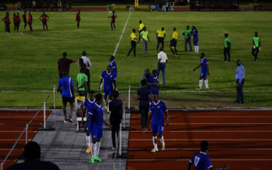 Members of Pele FC in the process of walking off the field in a protest which led to the abandoning of their fixture against Alpha United in the GFF Stag Beer Elite League at the Leonora Sports Facility.