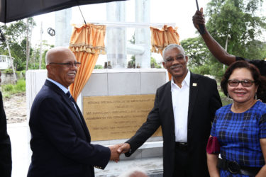 President David Granger, flanked on the right by First Lady Sandra Granger, shakes hands with Chairman of Banks DIH Limited Clifford Reis. Banks DIH funded the construction of the Independence Arch, a project that was conceptualised earlier this year, according to Minister of Public Infrastructure David Patterson. (Photo by Keno George)