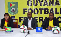 Guyana Football Federation President Wayne Forde (centre) addressing the gathering while Golden Jaguars Head-coach Jamaal Shabazz (right) and GFF Director of Communications Debra Francis looks on.