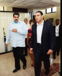 Venezuelan president Nicolas Maduro (left) talks with Prime Minister Andrew Holness on arrival at Jamaica House yesterday morning