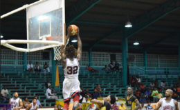 Winston Robinson of DC Jammers in the process of completing the monstrous ‘alley-oop’ during his side’s win over Road to Mecca champs Colts at the Cliff Anderson Sports Hall. Back page picture 