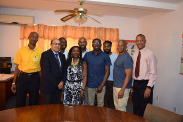 National triple jump record holder, Troy Doris (fourth from right) pose for a photo along with members of his family, GOA head, K Juman-Yassin, AAG president, Aubrey Hutson and Chef-De-Mission, Garfield Wiltshire. 