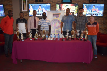 Organisers of the inaugural Professional Key Shop and the Wind Jammer Hotel Golden Mile along with some athletes and president of the AAG, Aubrey Hutson pose for a photo following the launch yesterday at 704 Sports Bar. 