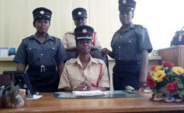 Divisional Fire Officer Administration Jacqueline Greene (seated) is flanked by Station Officer Marcia Bell (centre) and Firewomen Shavea Jordan (right) and Sophia Boucher (left).