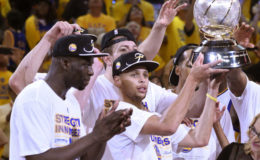 Golden State guard Stephen Curry celebrates with the Western Conference championship trophy after the Warriors beat the Houston Rockets in the NBA Playoffs at Oracle Arena.
