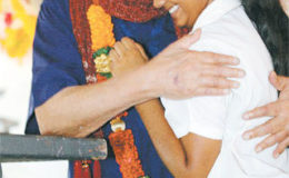 Sanatan Dharma Maha Sabha Secretary General Satnarayan Maharaj hugs Keisha Rampersad, a student of Parvati Girls’ Hindu College, after she placed a garland around his neck on Monday during Indian Arrival Day celebrations in Debe.