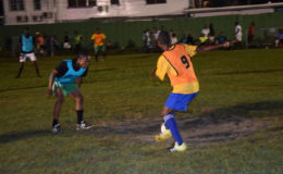  Job Caesar of Cross Street (left) trying to maintain possession of the ball while being challenged by an Old School Ballers defender during their matchup at the Santos Training Area in the Ministry of Health/Petra Soft Shoe Championship.
