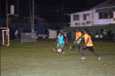 Terrence Lewis (right) of Old School Ballers trying to initiate an attacking play while being watched closely by Job Caesar of Cross Street during the opening fixture of the Ministry of Health/Petra Soft Shoe Championship at the Santos Training Area at the Square of the Revolution. 