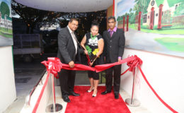 Mayor of Georgetown Patricia Chase-Green (centre) cuts the ribbon to open the new Tower Suites while Guyana Tourism Authority Director Indranauth Haralsingh (left) and Tower Suites Operations Manager Mr Hemraj (right) look on.