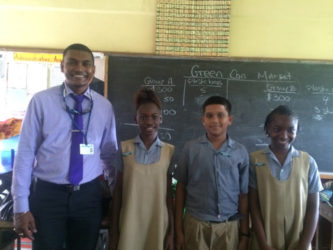 Solid Waste Director Walter Narine (left) and the environmental prefects at St Pius Primary