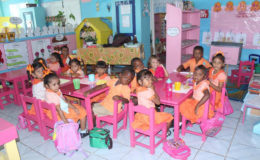 Nursery School students enjoying their snack of biscuits and juice as part of the national School Feeding Programme. (Photo courtesy of Ministry of Education) 