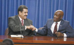 Venezuelan President Nicolas Maduro, left, and Prime Minister Dr Keith Rowley exchange a handshake during a joint press conference following bilateral talks at the Diplomatic Centre, St Ann's, yesterday.