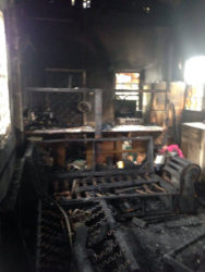 The destroyed kitchen and living room area after the fire 