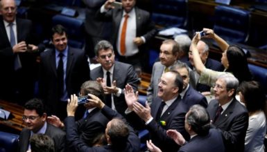 Members of Brazil's Senate react after a vote to impeach President Dilma Rousseff for breaking budget laws in Brasilia, Brazil, May 12, 2016. REUTERS/Ueslei Marcelino 