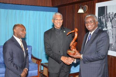 This Ministry of the Presidency photo shows Barbadian Prime Minister Freundel Stuart (right) presenting a gift to President David Granger. Foreign Minister Carl Greenidge is also in the photo.