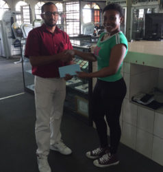 A Buddy’s Gym representative presents the cheque to GAPF Secretary, Melissa Tucker.