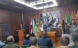 President David Granger (right in background) receiving the Commission of Inquiry’s Report into the Georgetown Prison unrest from Chairman of the Commission, Justice James Patterson. (Ministry of the Presidency photo)
